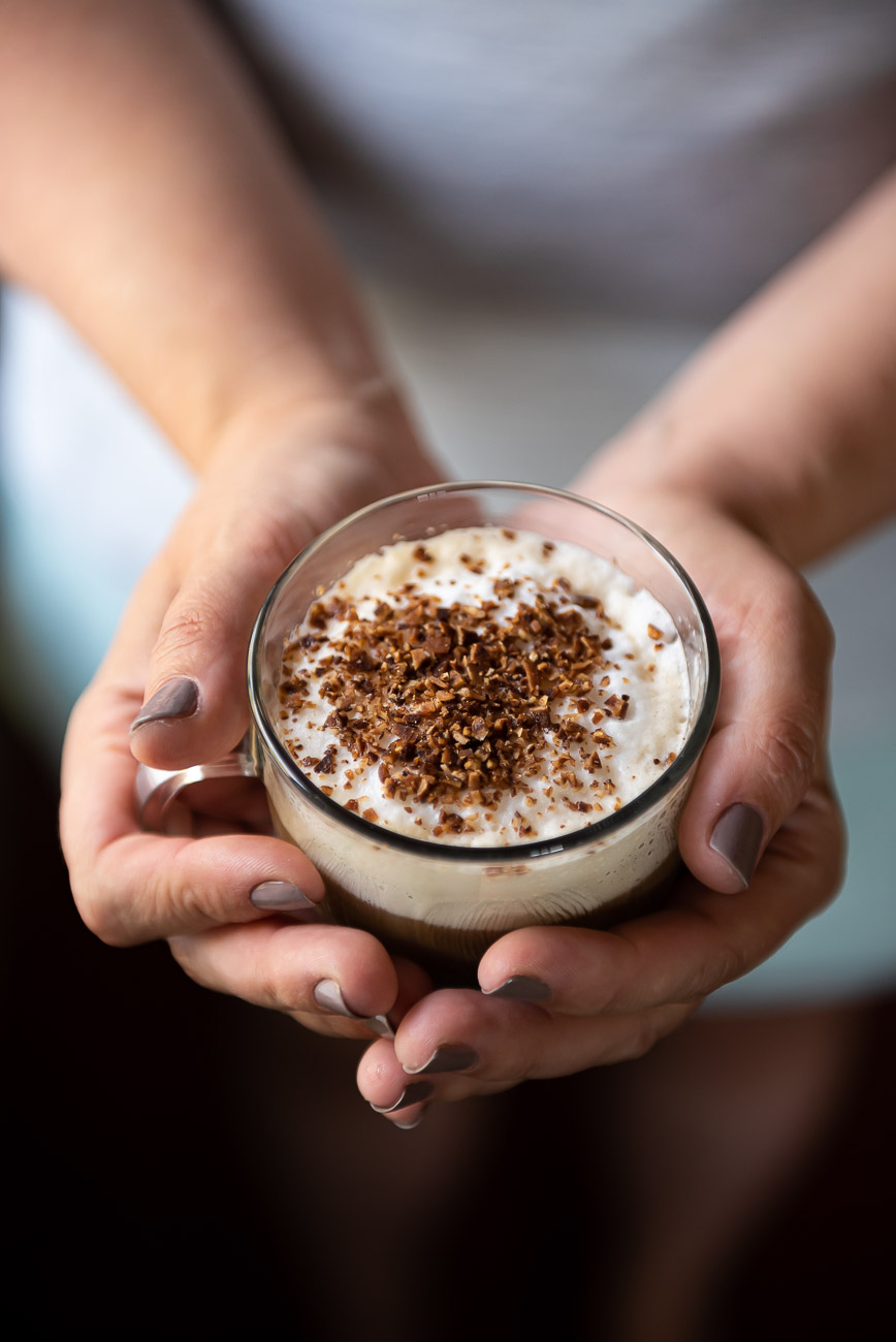 Example of leading lines in food photography, hands holding coffee