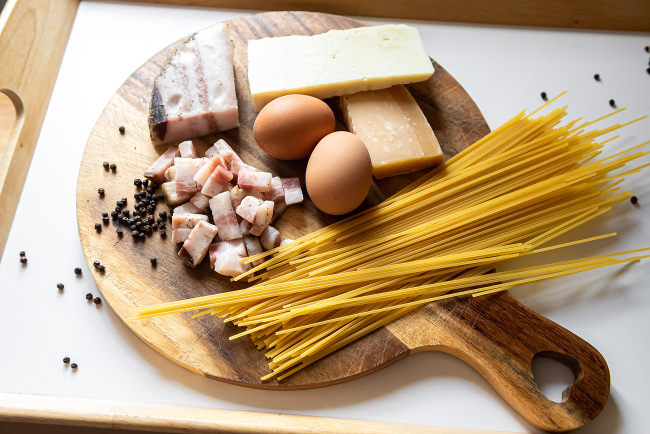Authentic Spaghetti alla Carbonara ingredients on a board