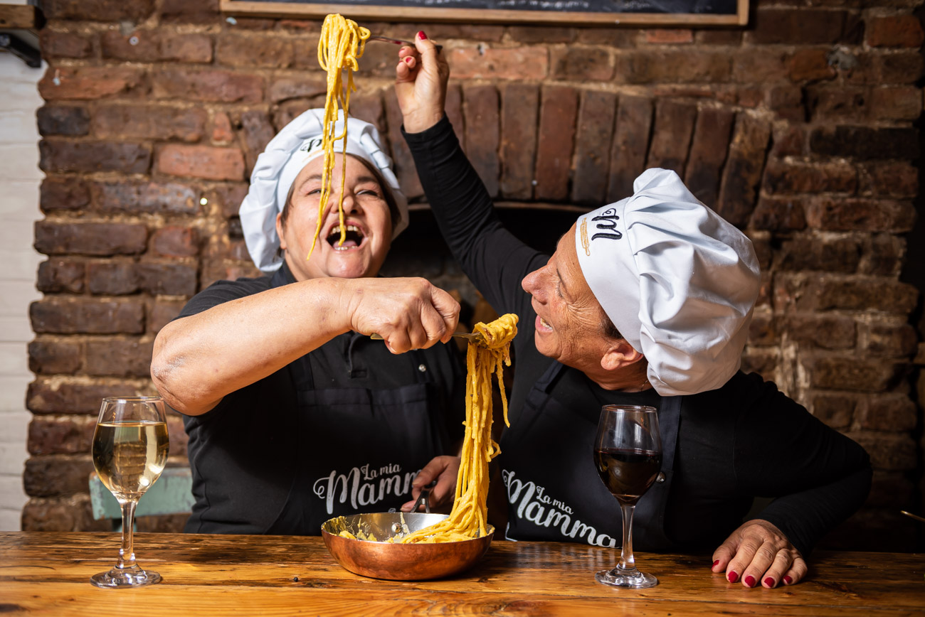 women feeding each other spaghetti alla carbonara